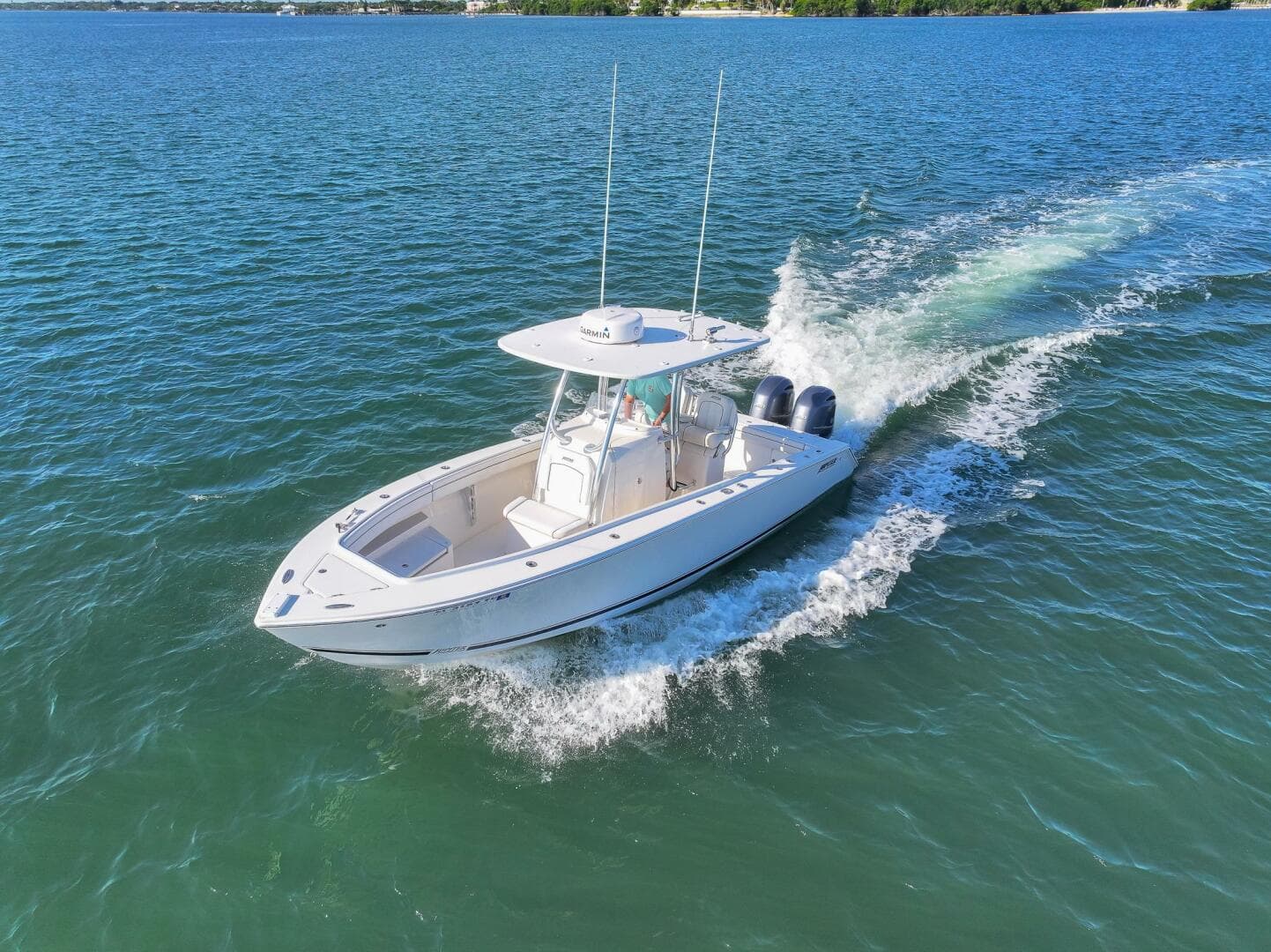 2018 Jupiter 26 FS boat cruising on open water, showcasing sleek design and powerful engines.