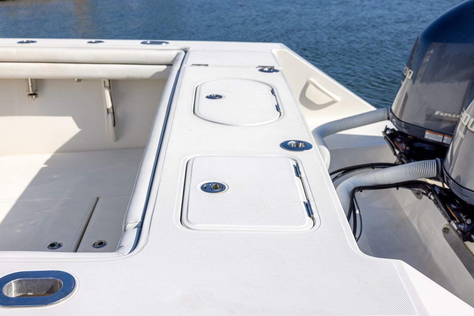 2018 Jupiter 26 FS boat deck with storage compartments and dual engines.
