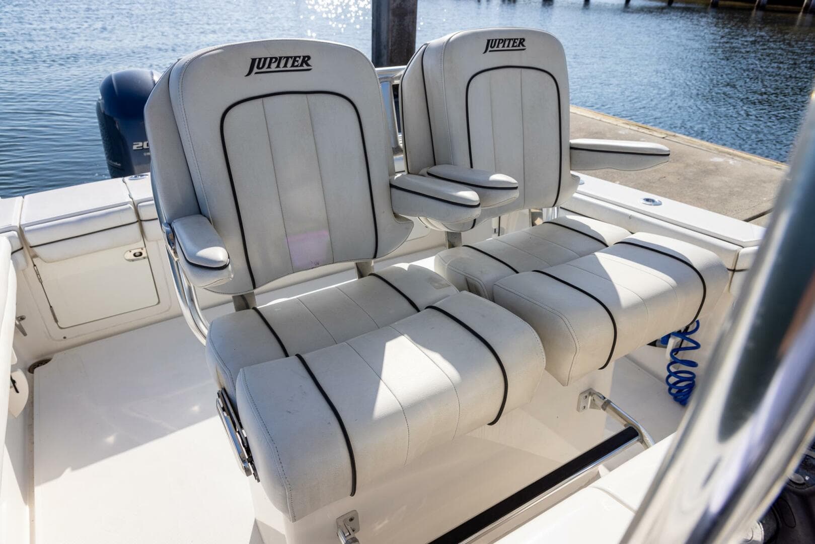 2018 Jupiter 26 FS boat seats, white with black trim, docked by the water.