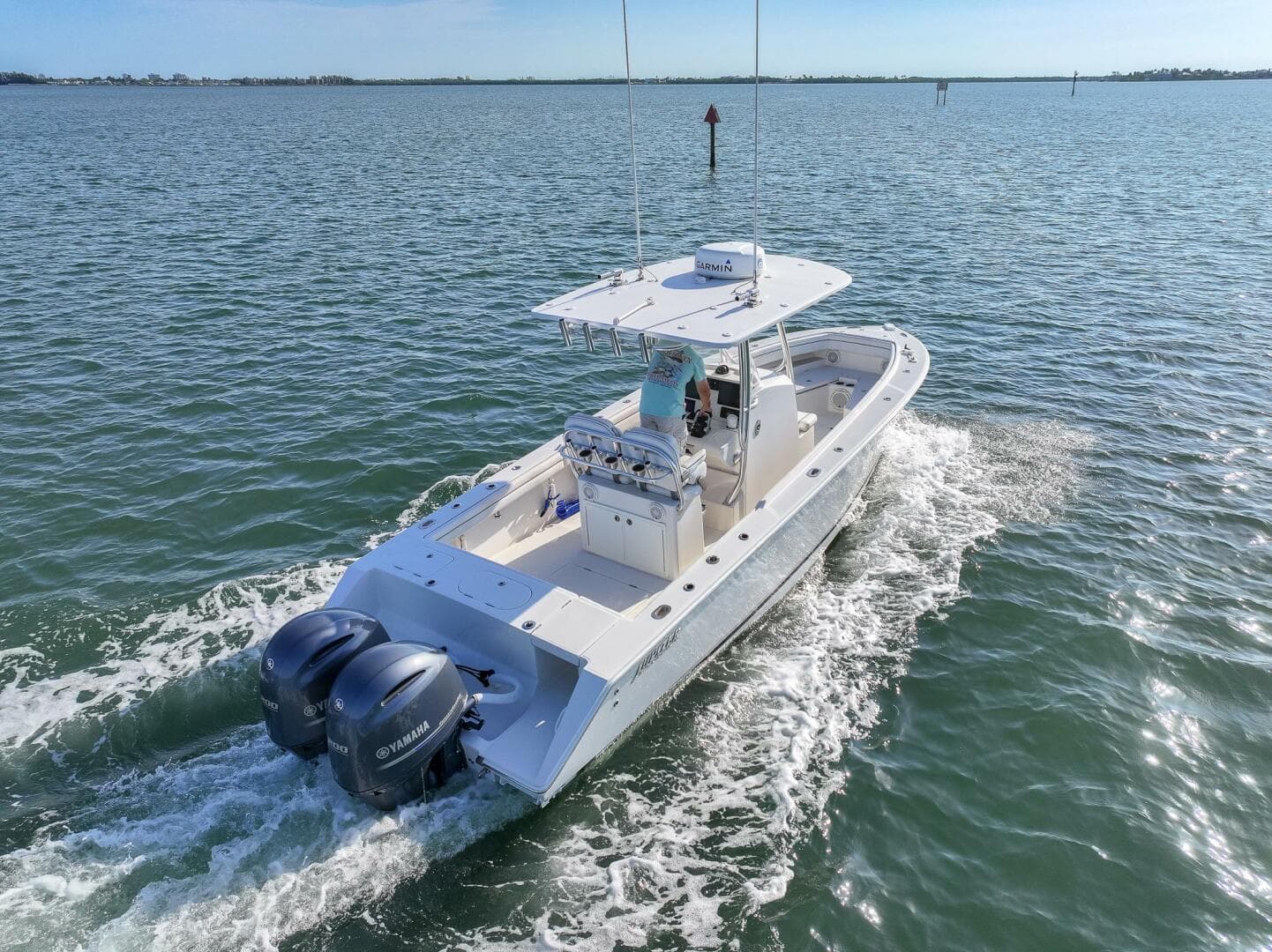 2018 Jupiter 26 FS boat cruising on open water with twin engines.