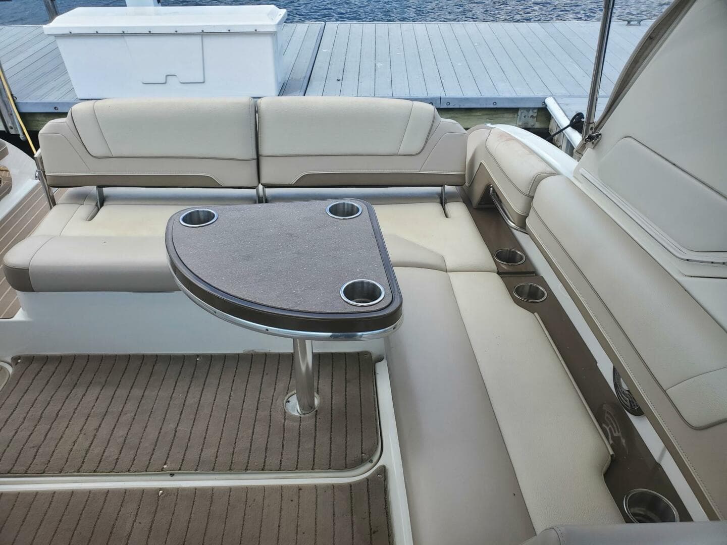 2015 Formula 330 Crossover Bowrider interior with cushioned seating and table.
