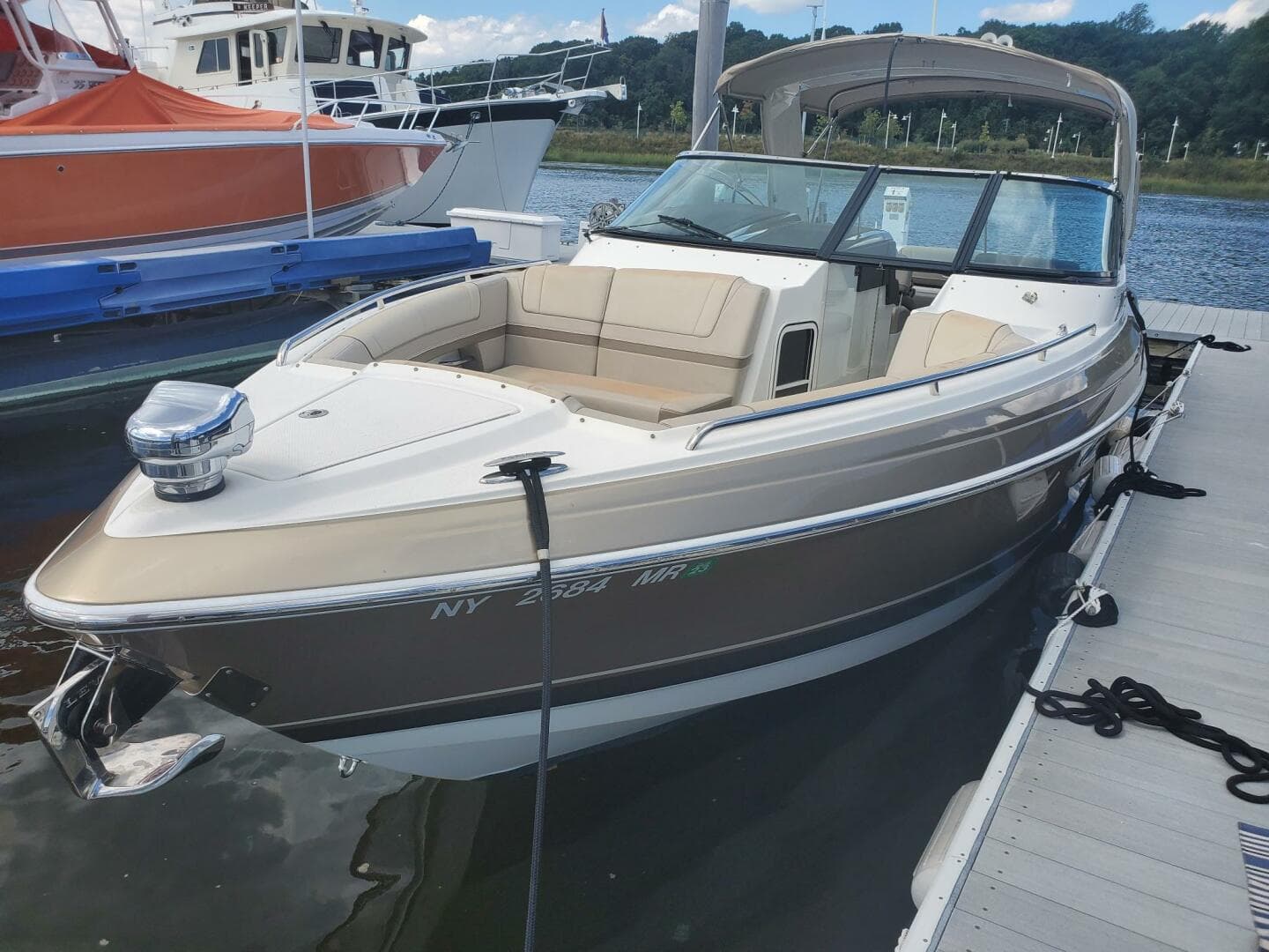 2015 Formula 330 Crossover Bowrider docked, featuring sleek design and spacious seating.