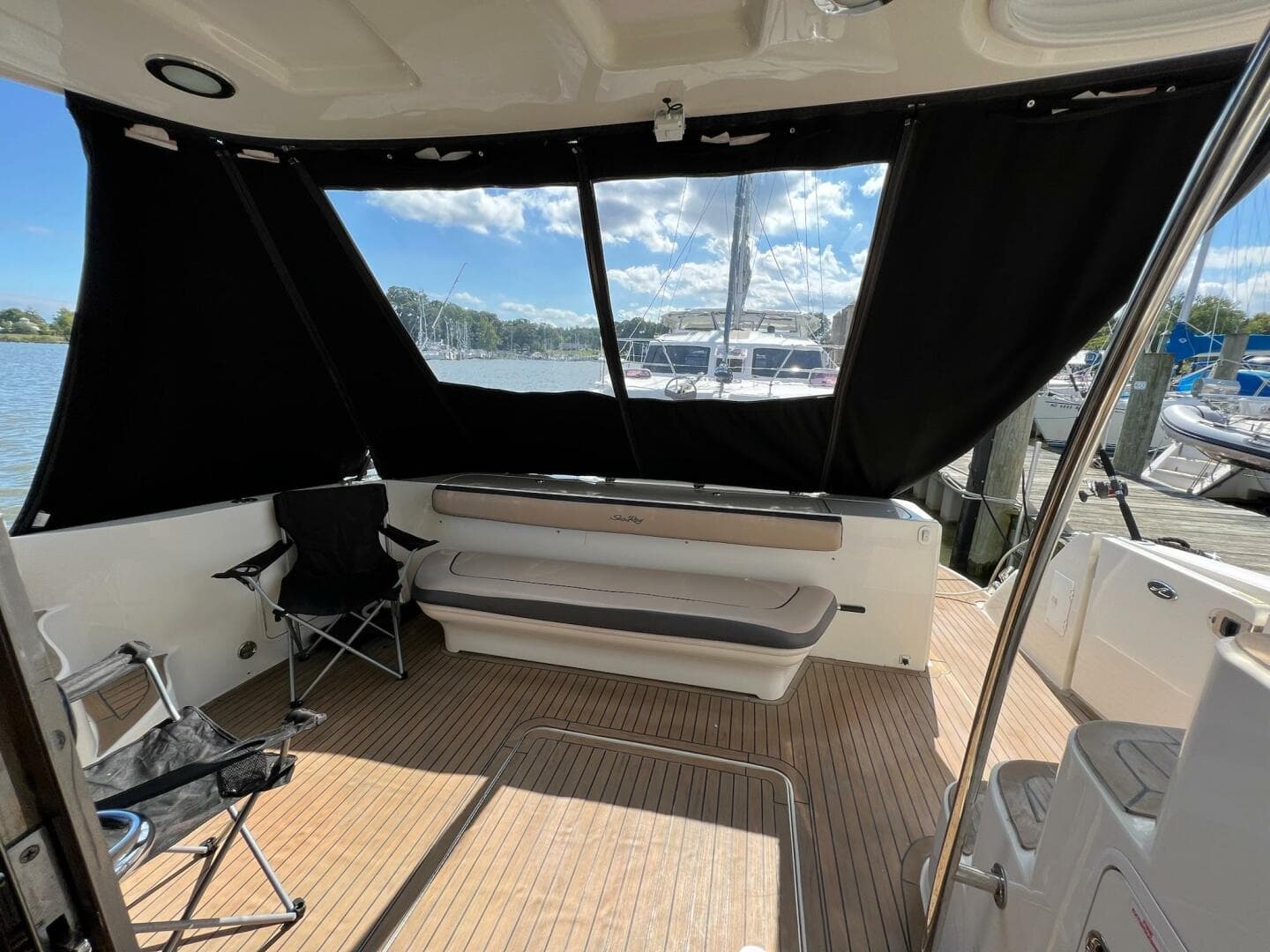 2005 Sea Ray 500 Sedan Bridge interior with seating, docked at marina.
