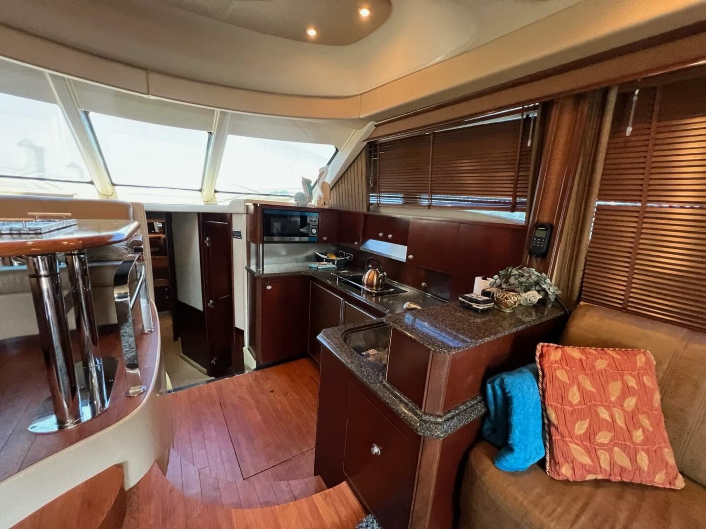 Luxurious interior of 2005 Sea Ray 500 Sedan Bridge yacht with modern kitchen and seating area.