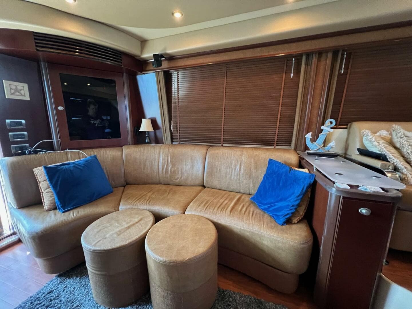 Luxurious interior of 2005 Sea Ray 500 Sedan Bridge with leather seating and nautical decor.