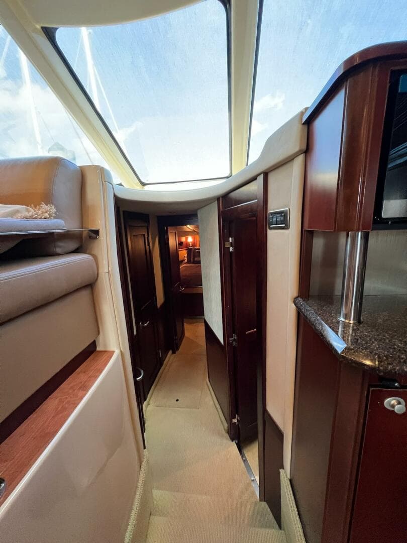 2005 Sea Ray 500 Sedan Bridge interior with skylight, luxurious wood finishes, and modern design.