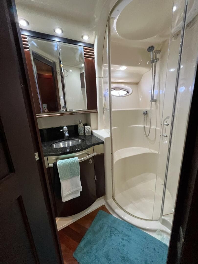 Luxurious bathroom in 2005 Sea Ray 500 Sedan Bridge yacht with shower and vanity.