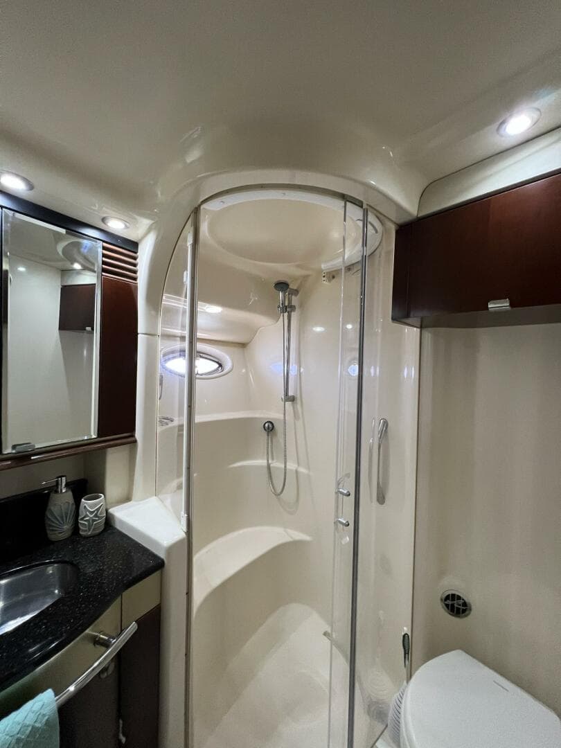 Luxurious bathroom in 2005 Sea Ray 500 Sedan Bridge yacht with modern shower and sleek design.