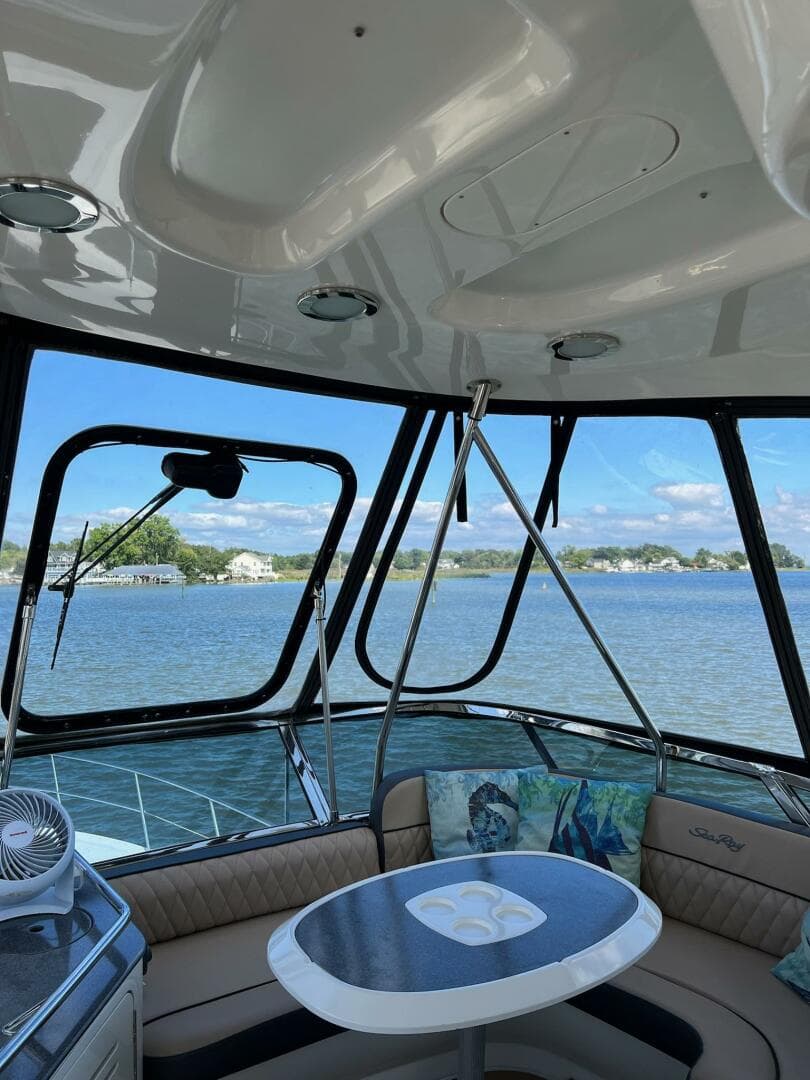 Interior view of 2005 Sea Ray 500 Sedan Bridge yacht with scenic water backdrop.