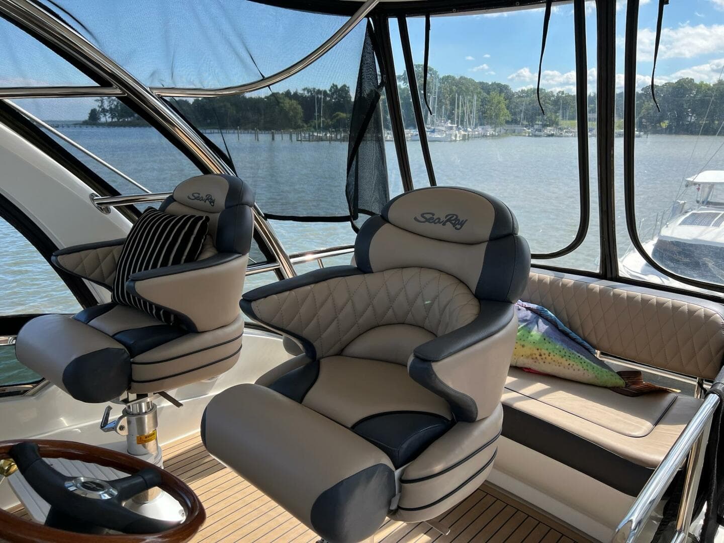 Luxurious 2005 Sea Ray 500 Sedan Bridge interior with plush seating and scenic water view.