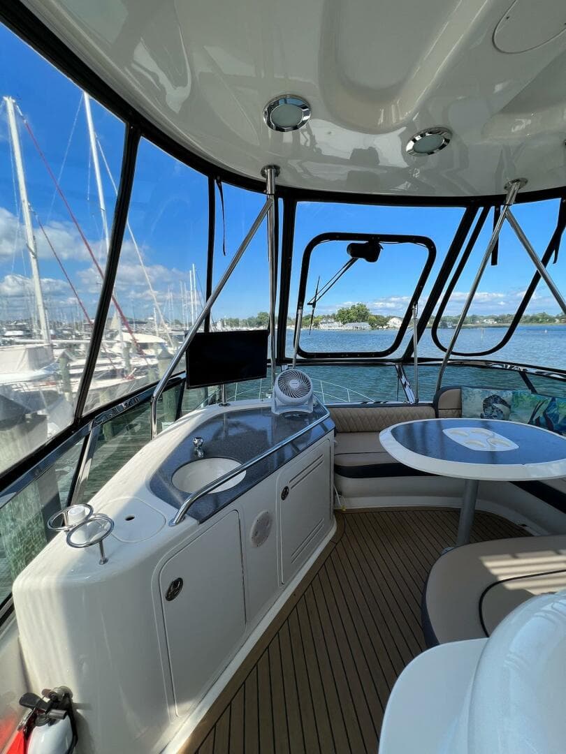 Interior of 2005 Sea Ray 500 Sedan Bridge yacht with seating and marina view.