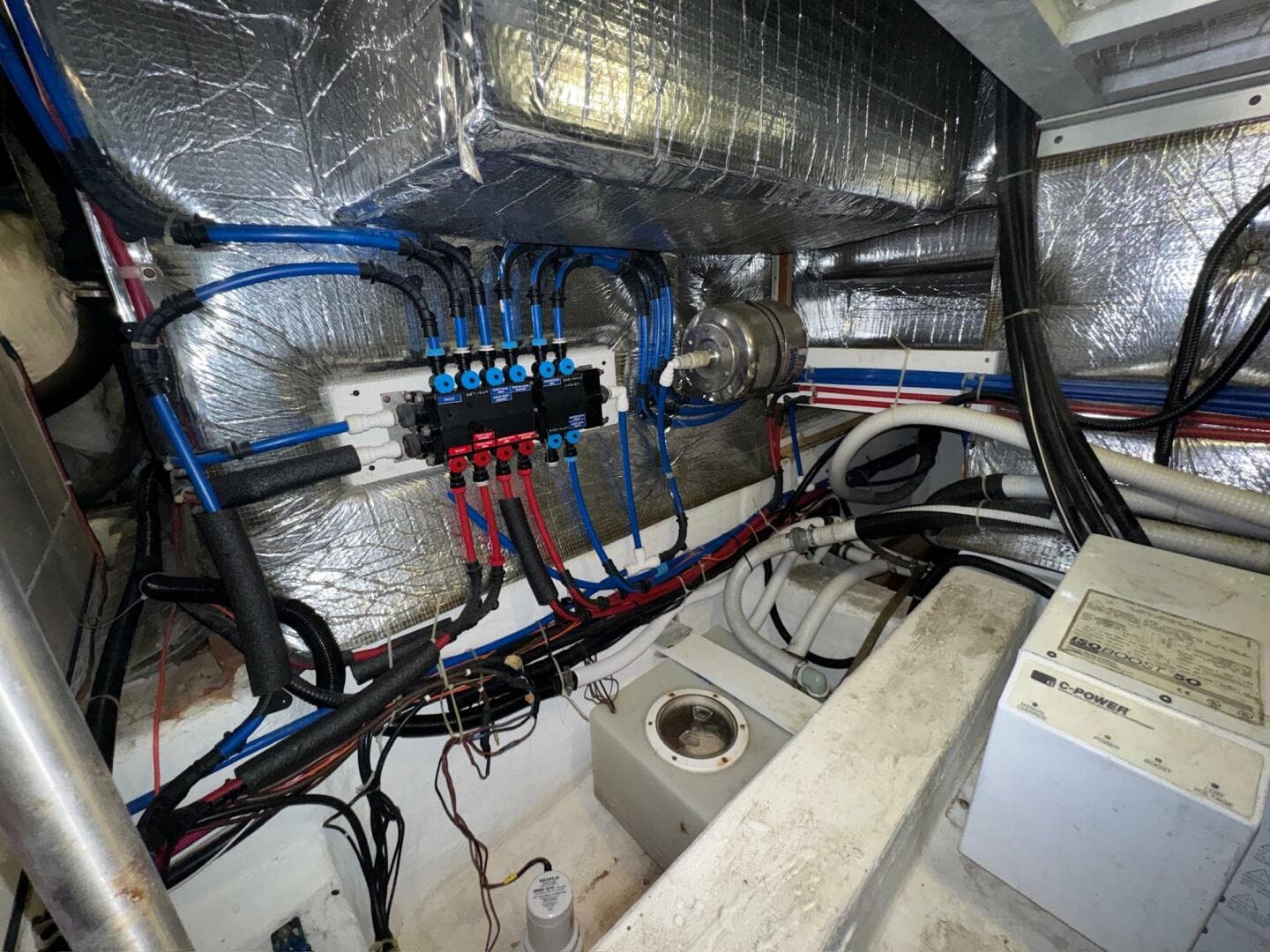 Engine room of a 2000 Carver 506 Motor Yacht with wiring and insulation.