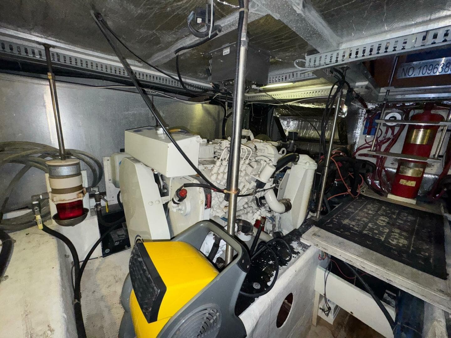 Engine room of a 2000 Carver 506 Motor Yacht, featuring mechanical components and wiring.