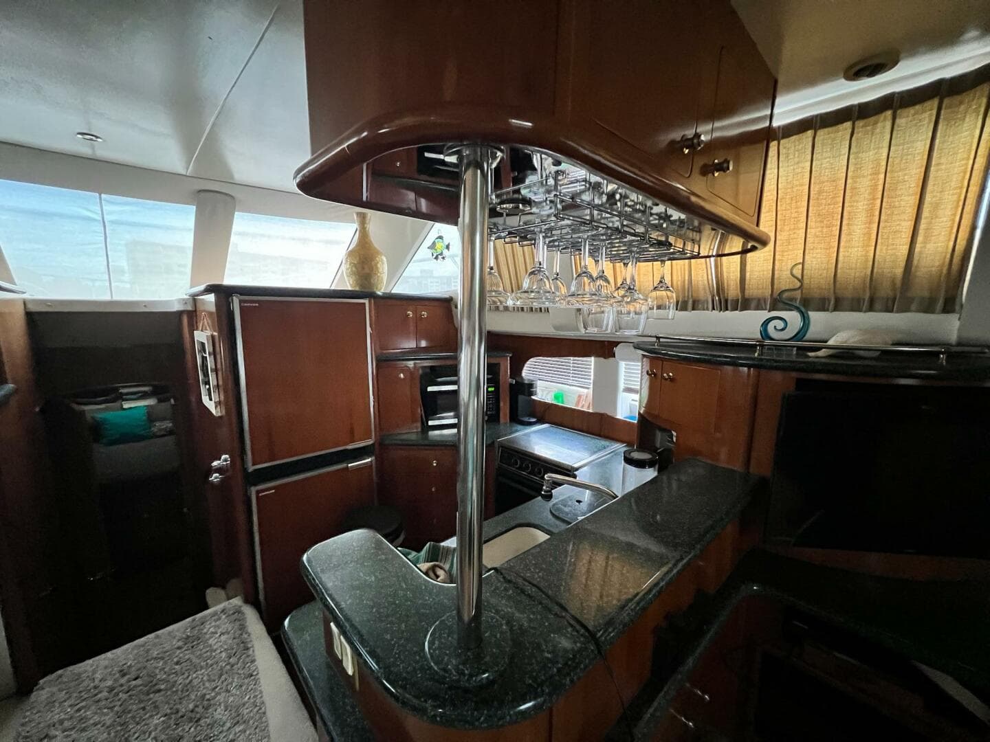 Luxurious interior of 2000 Carver 506 Motor Yacht with elegant wood and glass accents.