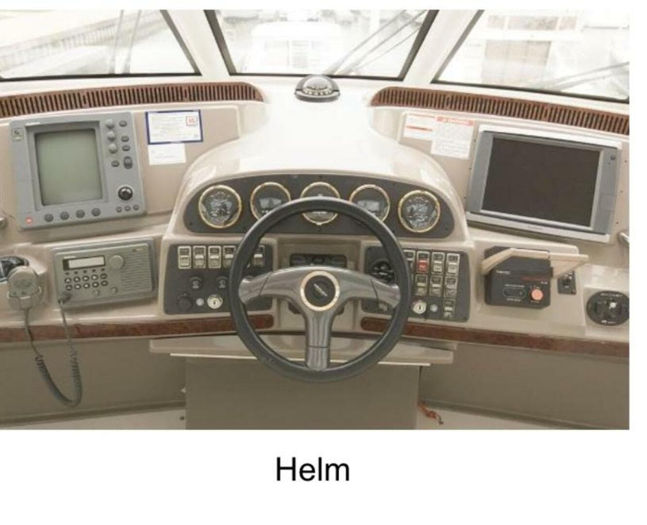 Helm of 2000 Carver 506 Motor Yacht with navigation instruments and steering wheel.