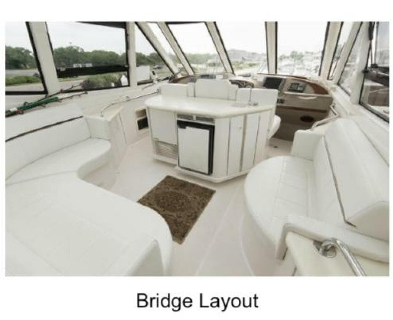 Bridge layout of 2000 Carver 506 Motor Yacht with white seating and helm.
