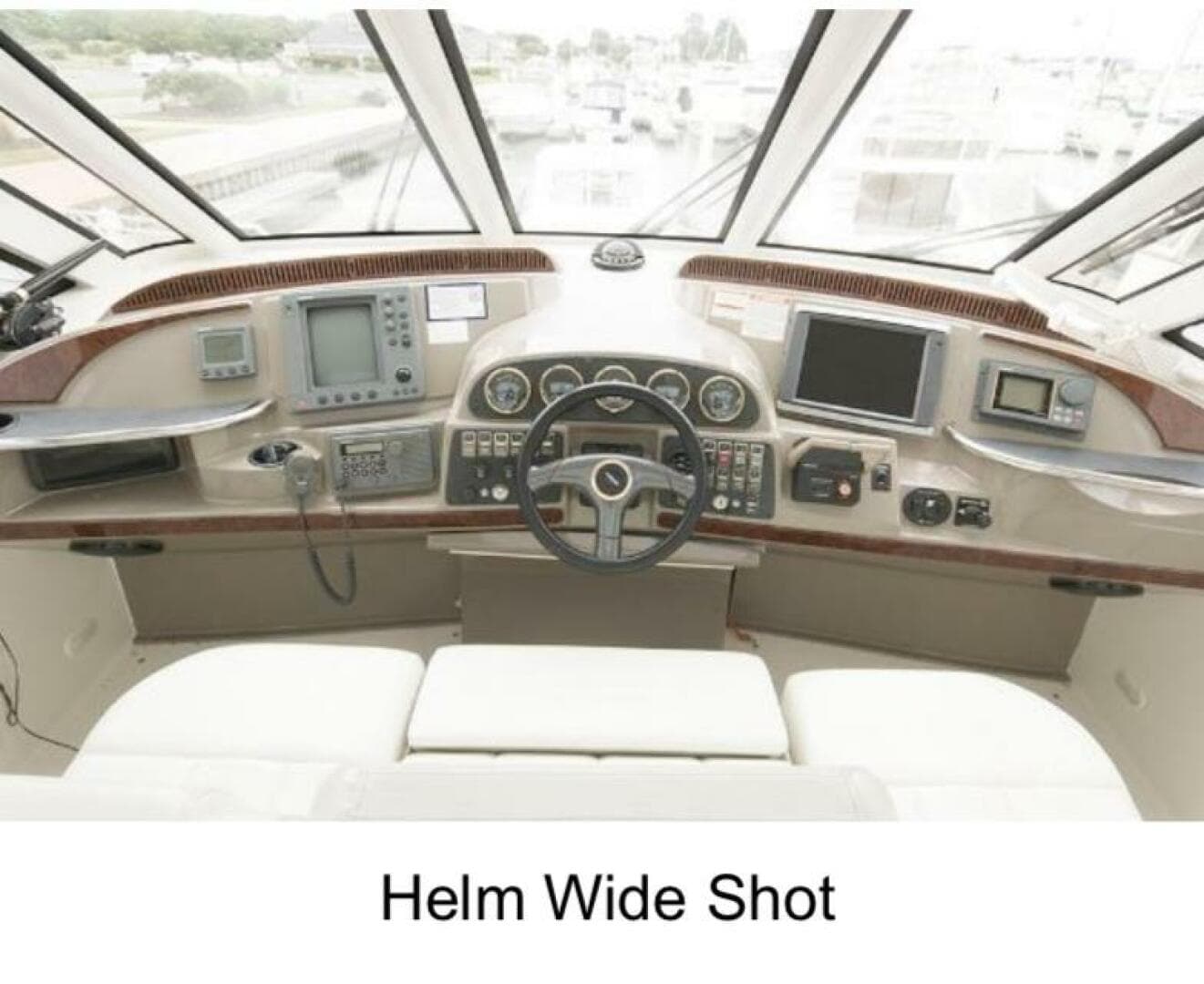 Helm of 2000 Carver 506 Motor Yacht with navigation instruments and steering wheel.