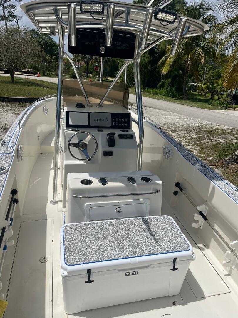 1998 Blue Fin 25 Center Console boat with modern controls and seating, set outdoors.