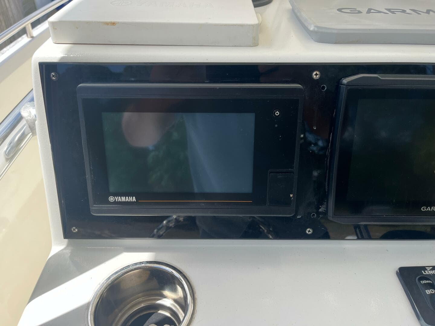 Control panel of a 1998 Blue Fin 25 Center Console boat with Yamaha and Garmin displays.