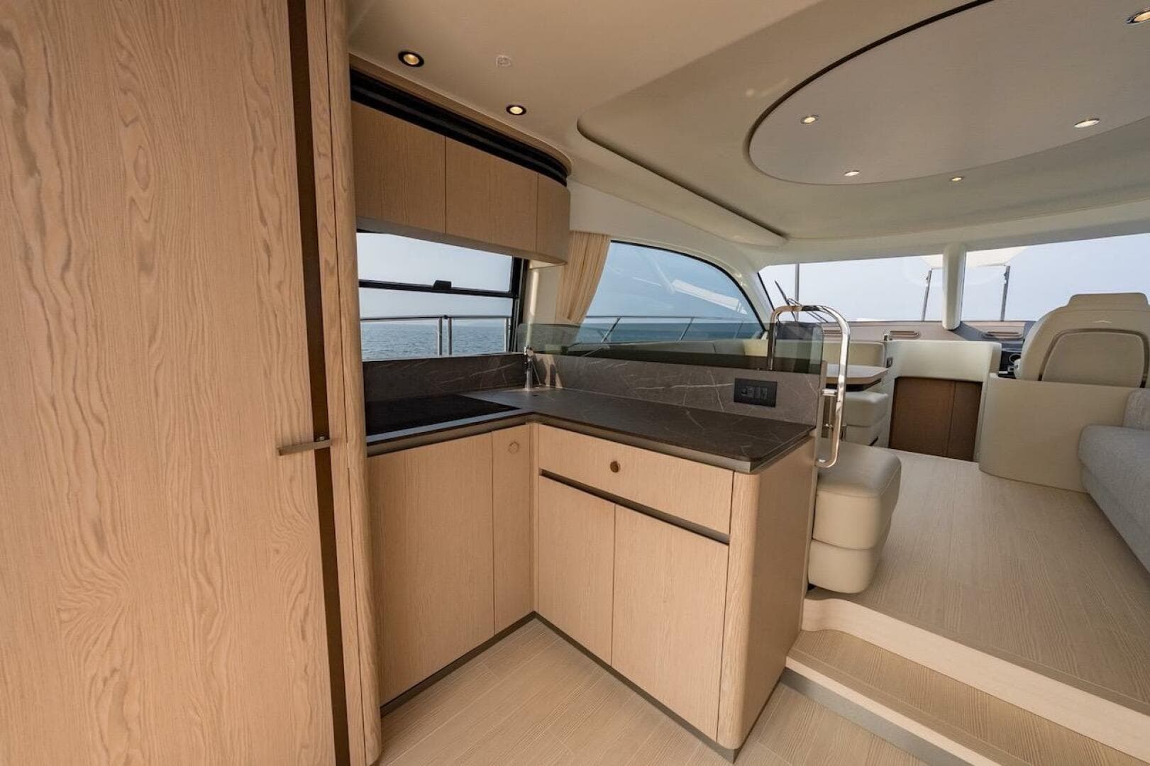 Luxurious interior of 2023 Azimut Fly 53 yacht, featuring modern kitchen and seating area.
