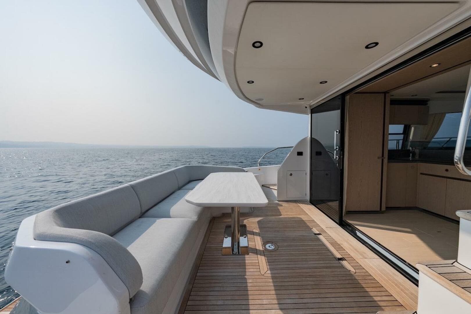 Luxurious 2023 Azimut Fly 53 yacht deck with ocean view and elegant seating area.