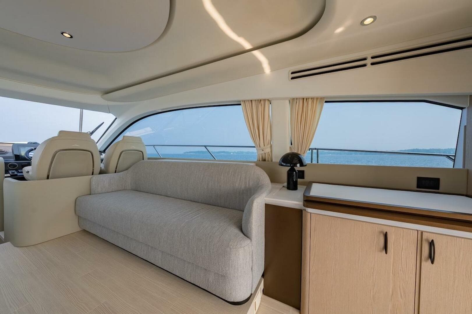 Interior of 2023 Azimut Fly 53 yacht with modern seating and ocean view.