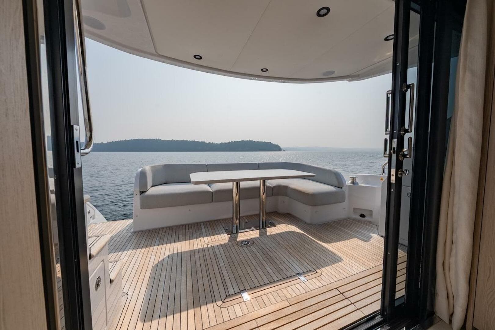 Luxurious 2023 Azimut Fly 53 yacht deck with seating, overlooking serene ocean view.