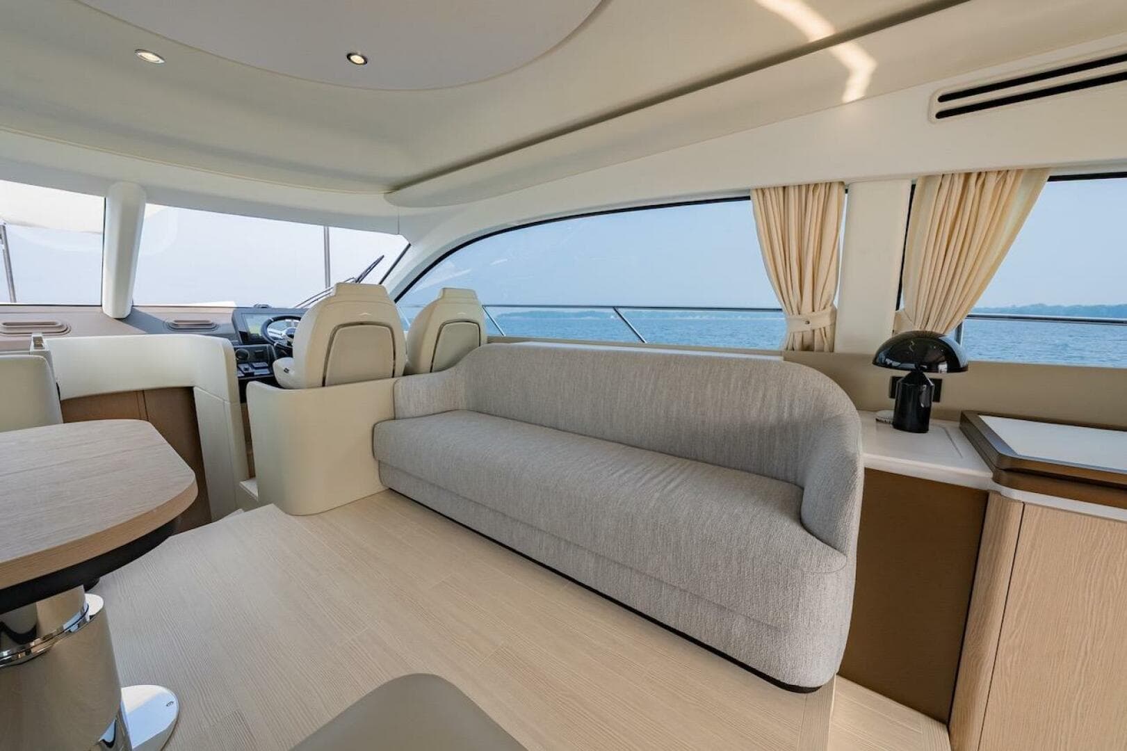 Luxurious interior of 2023 Azimut Fly 53 yacht with modern seating and ocean view.