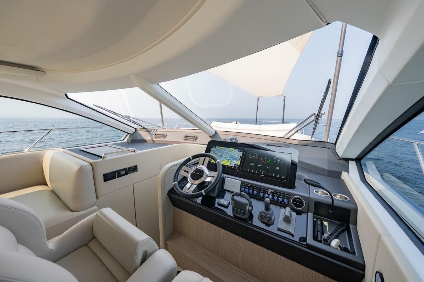 Luxurious 2023 Azimut Fly 53 yacht cockpit with modern navigation system and ocean view.