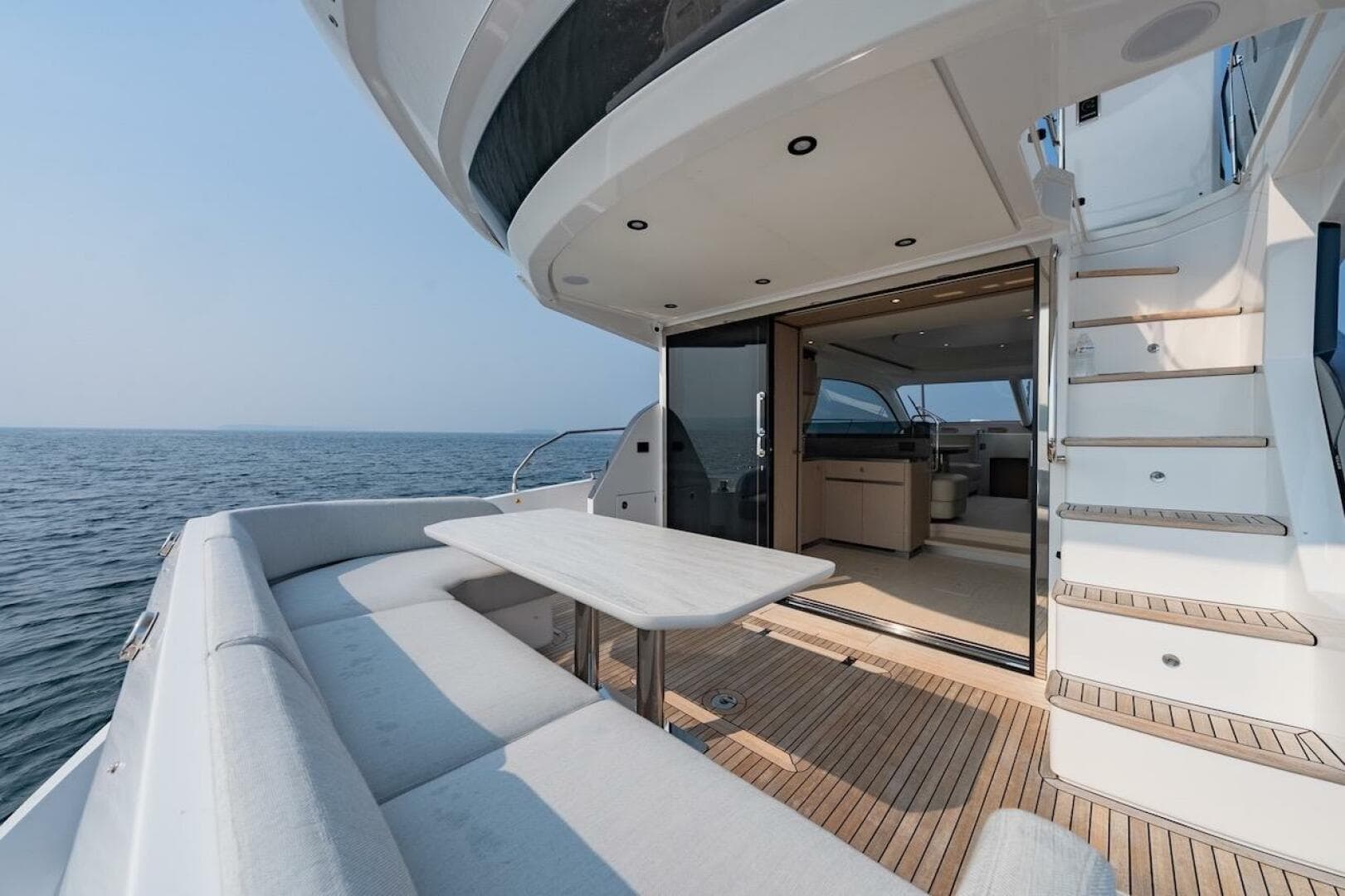 Luxurious 2023 Azimut Fly 53 yacht with elegant deck seating and ocean view.