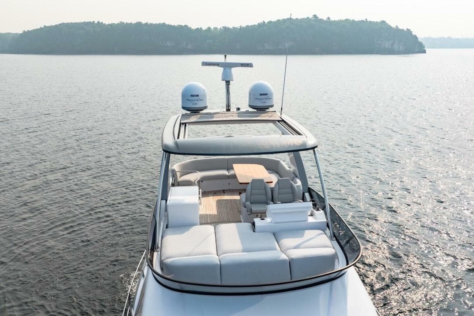 2023 Azimut Fly 53 yacht cruising on serene waters, showcasing luxurious deck seating.