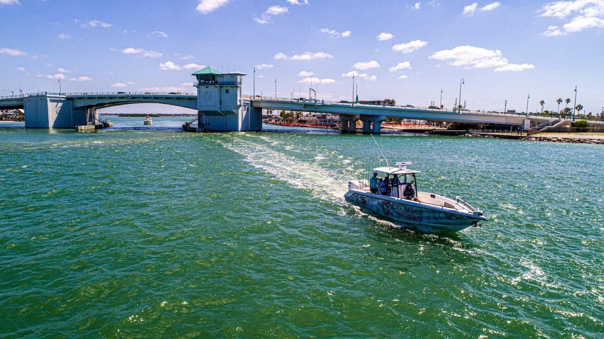 2023 CG Boat Works 35 M-Series cruising under a sunny bridge.