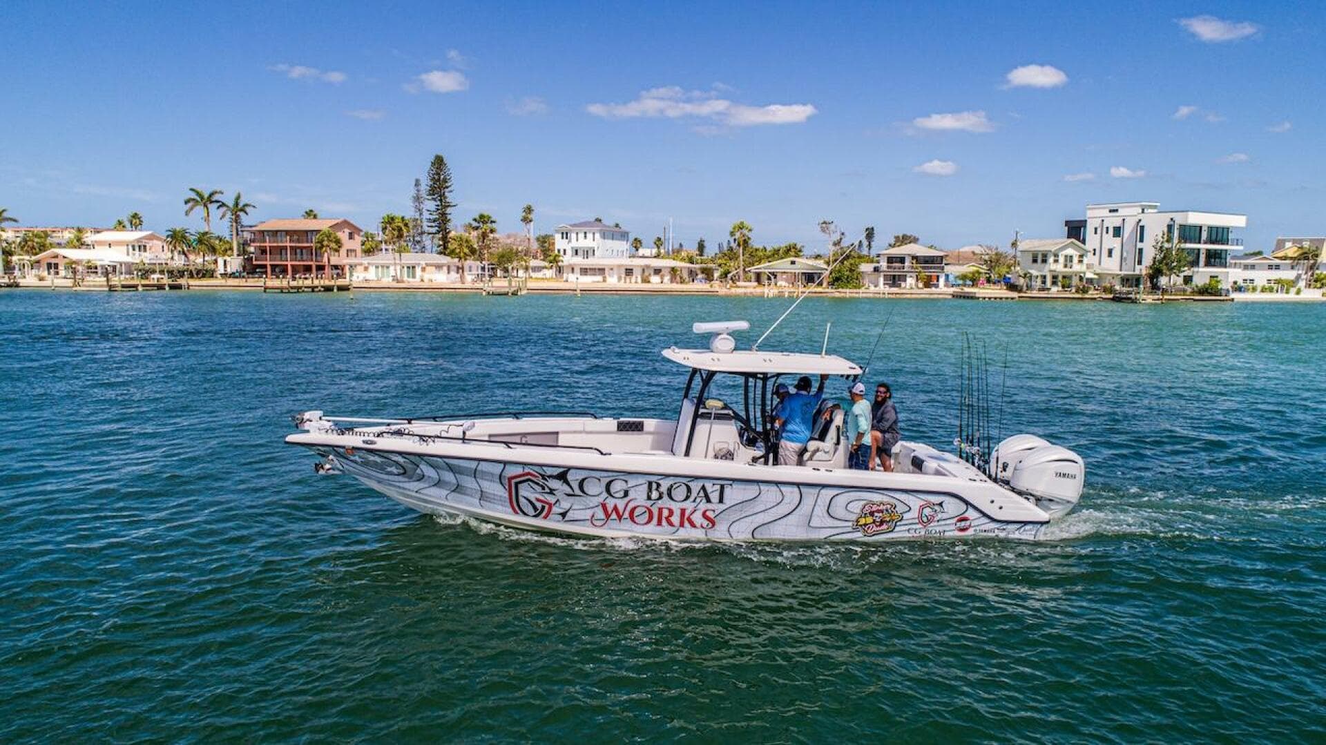 2023 CG Boat Works 35 M-Series cruising on a sunny day near waterfront homes.