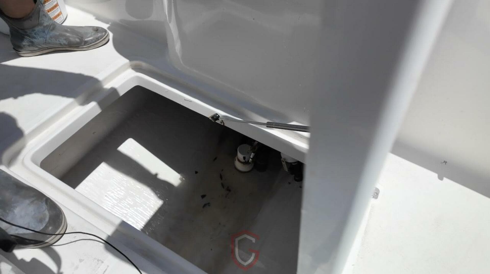 Open compartment on 2023 CG Boat Works 35 M-Series deck, showing interior details.