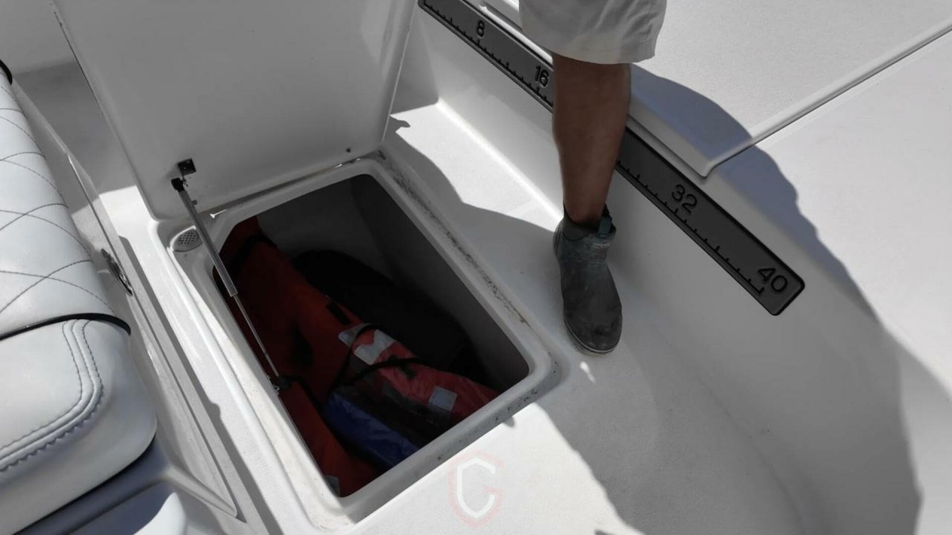 Open storage compartment on 2023 CG Boat Works 35 M-Series, featuring a measuring scale.