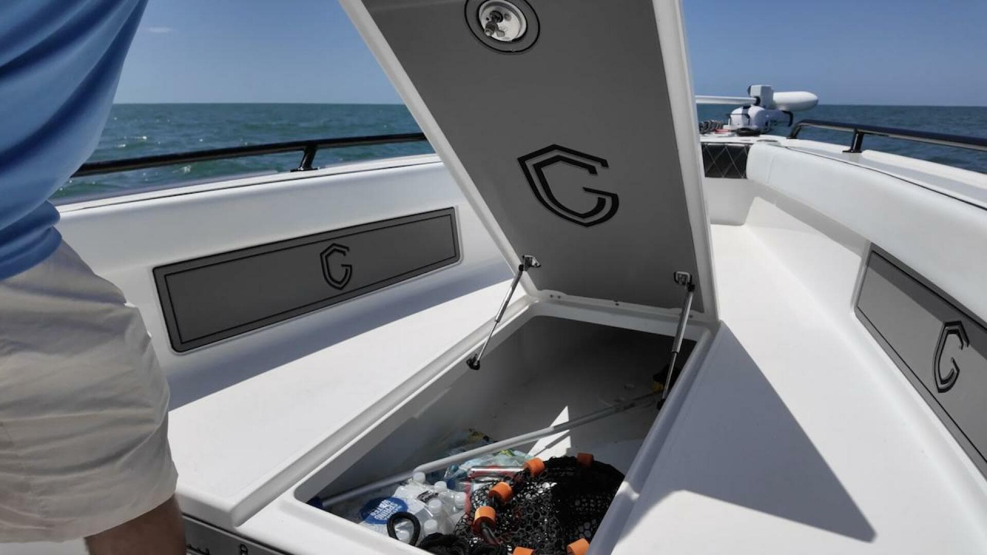 2023 CG Boat Works 35 M-Series open storage compartment on deck, ocean in background.