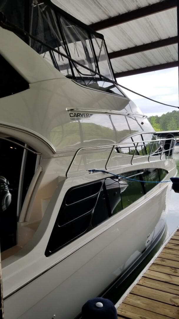 2004 Carver 360 Sport Sedan docked under a covered marina.