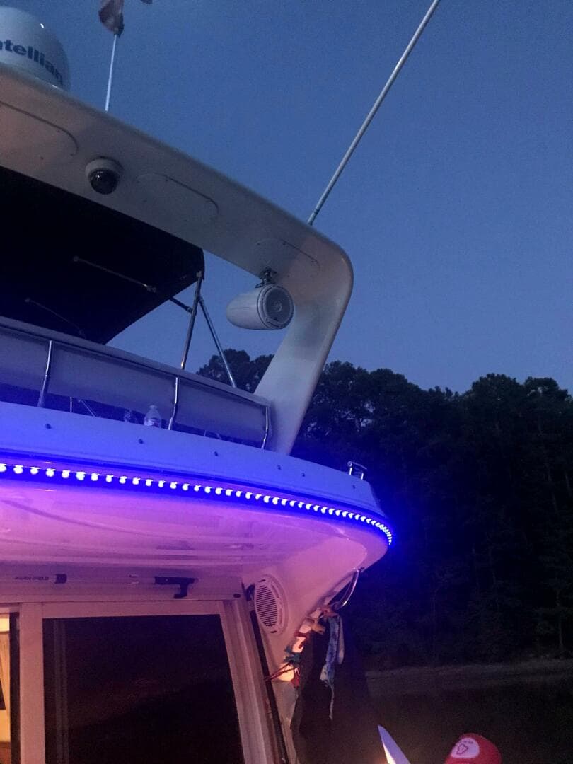 2004 Carver 360 Sport Sedan with blue LED lights at dusk.