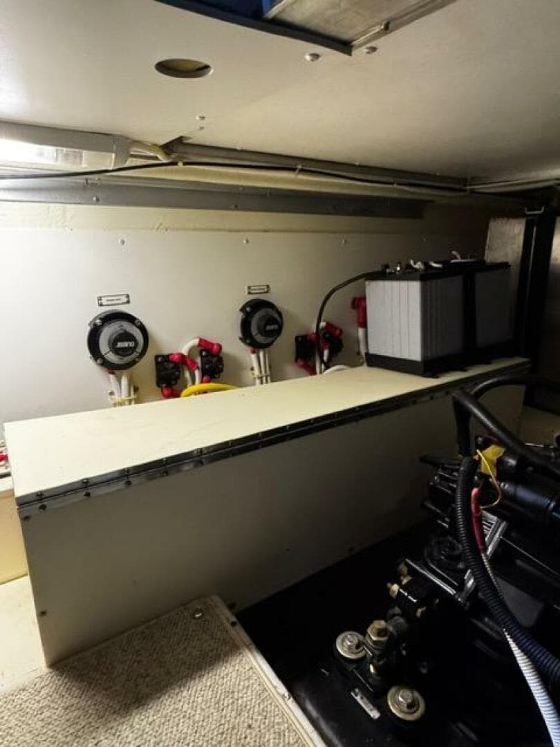 Engine room of a 2004 Carver 360 Sport Sedan with battery and control panels.