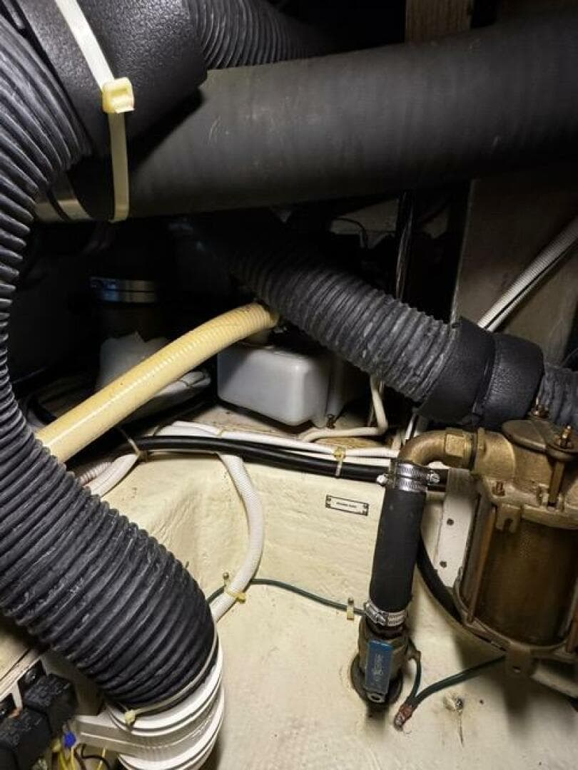 Engine compartment of a 2004 Carver 360 Sport Sedan with hoses and mechanical components.
