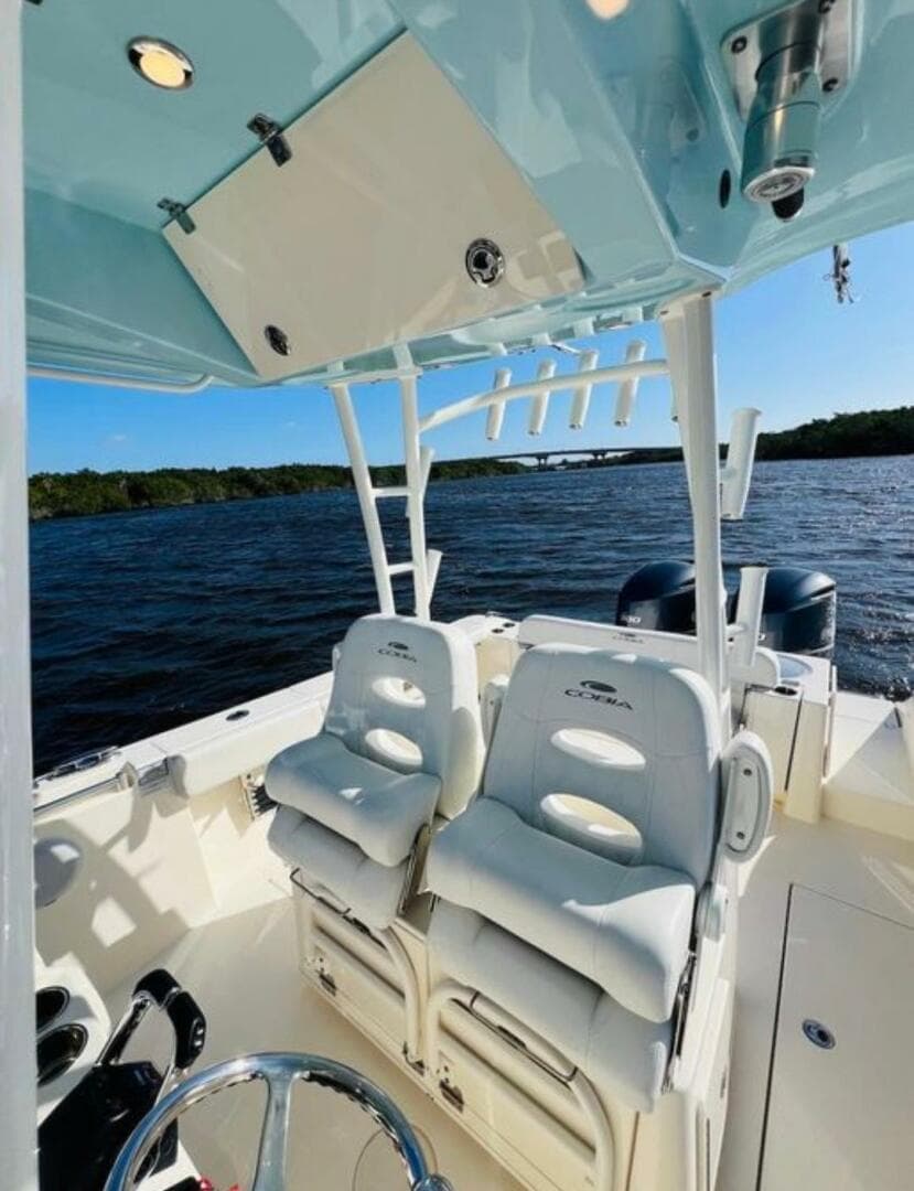 2021 Cobia 301 Center Console boat interior with seating, on a sunny day at sea.