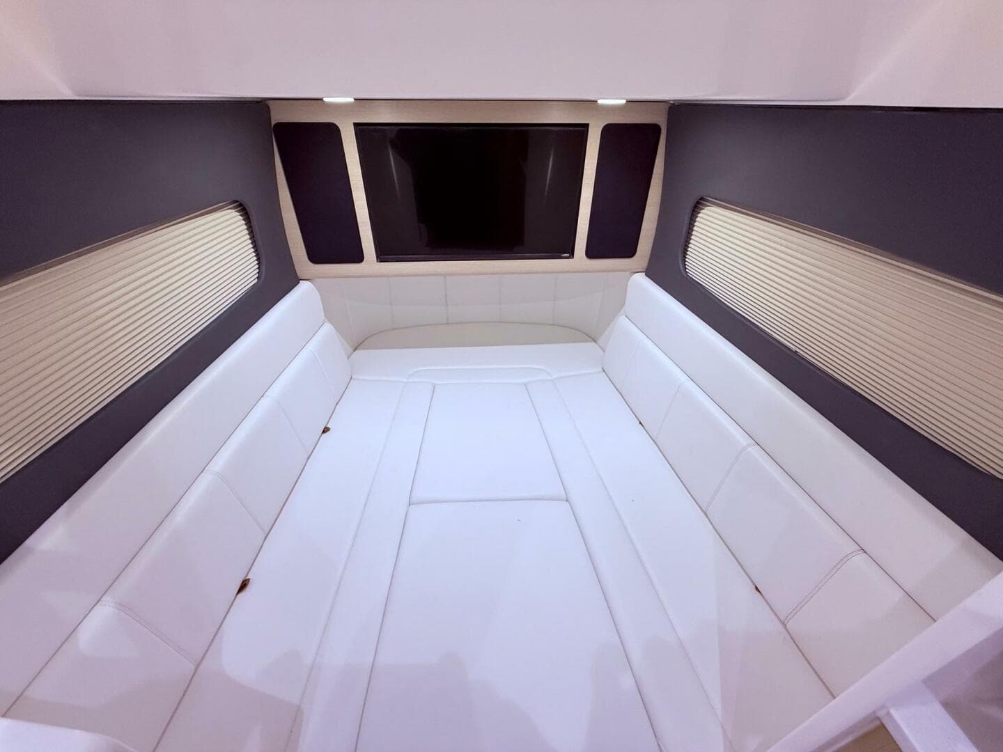 Luxurious interior cabin of 2024 Scout 400 LXF boat with white seating.
