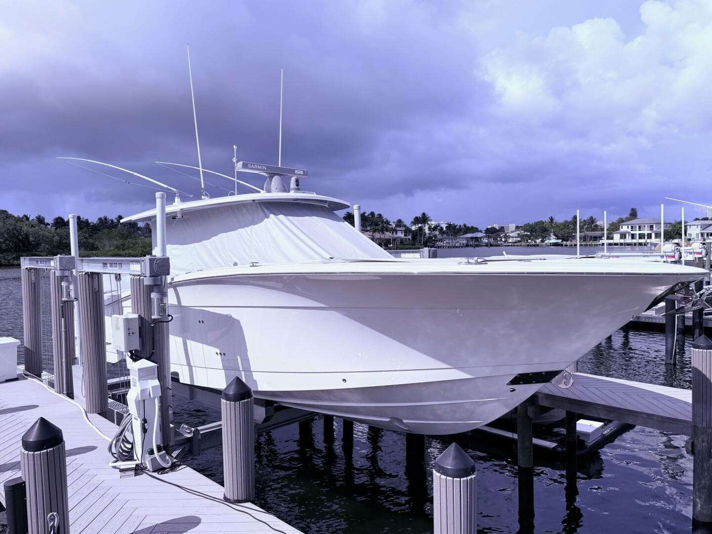 2024 Scout 400 LXF boat docked at marina under cloudy sky.