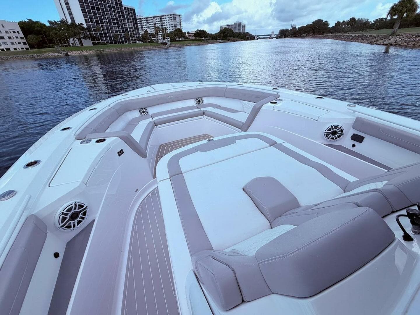 2024 Scout 400 LXF boat interior with luxurious seating on a calm waterway.