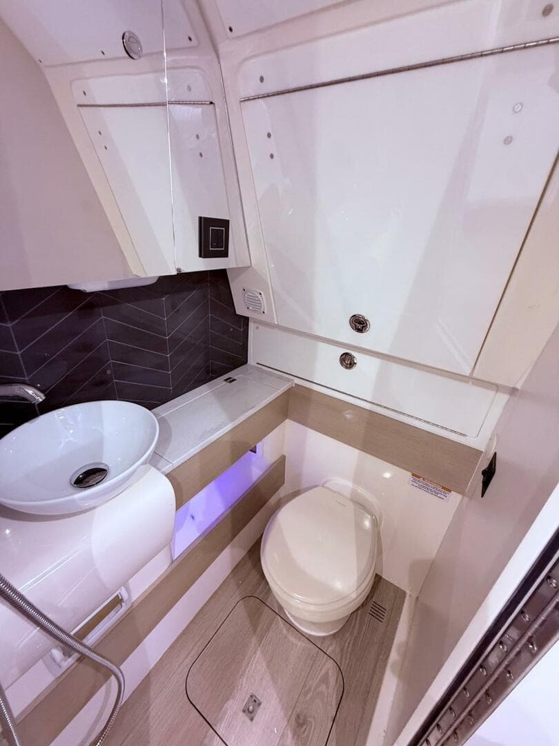 2024 Scout 400 LXF boat bathroom with modern sink and toilet.