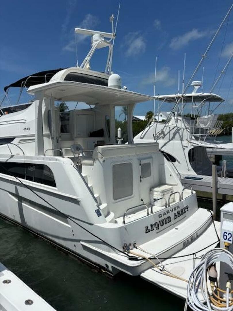 2006 Carver 43 Motor Yacht docked at marina under clear blue sky.