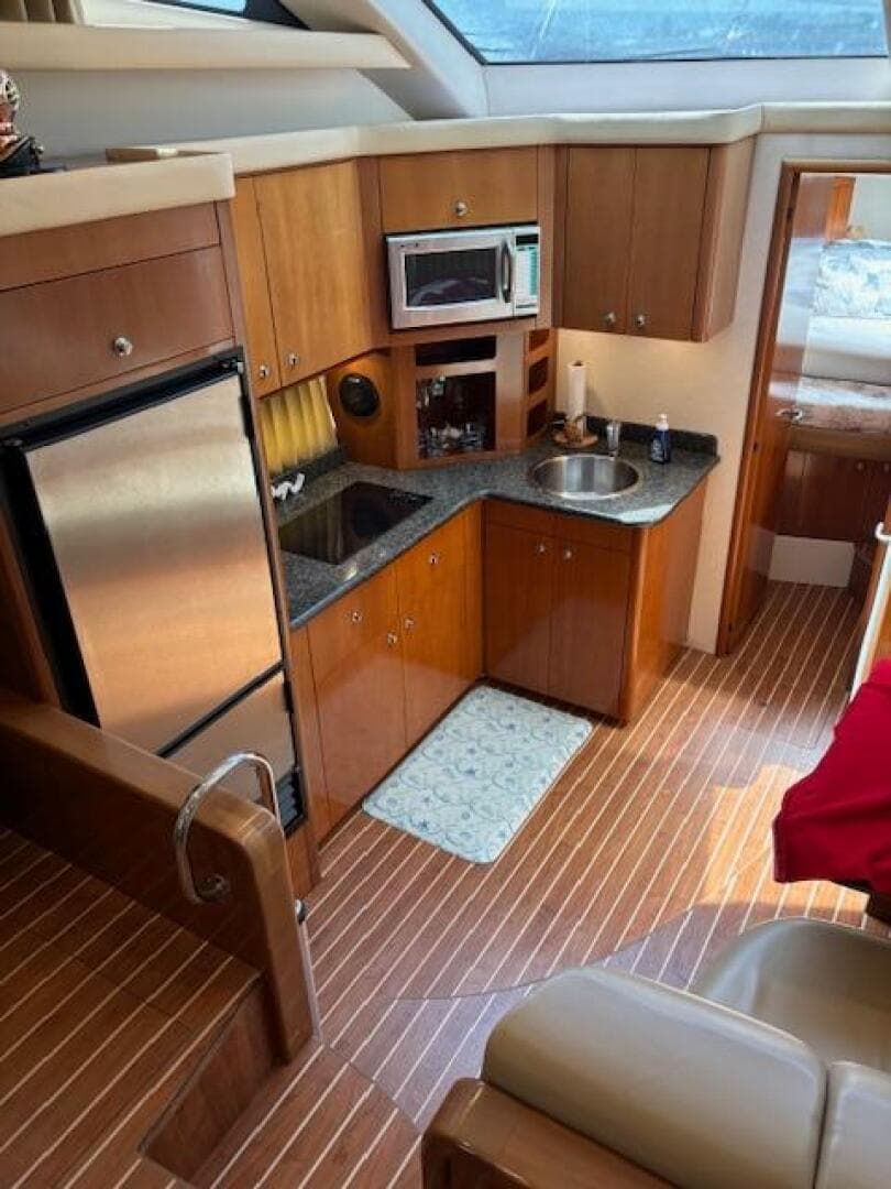 Interior of 2006 Carver 43 Motor Yacht with kitchen and wood flooring.