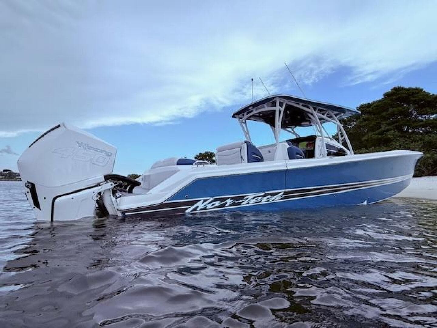 2022 Nor-Tech 390 Sport Center Console boat in water, showcasing sleek design and powerful engine.