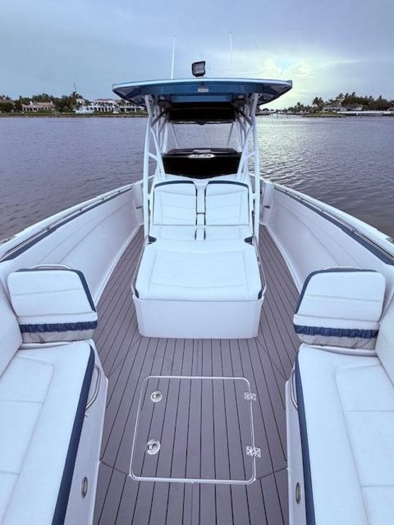 2022 Nor-Tech 390 Sport Center Console boat with spacious seating on calm water.