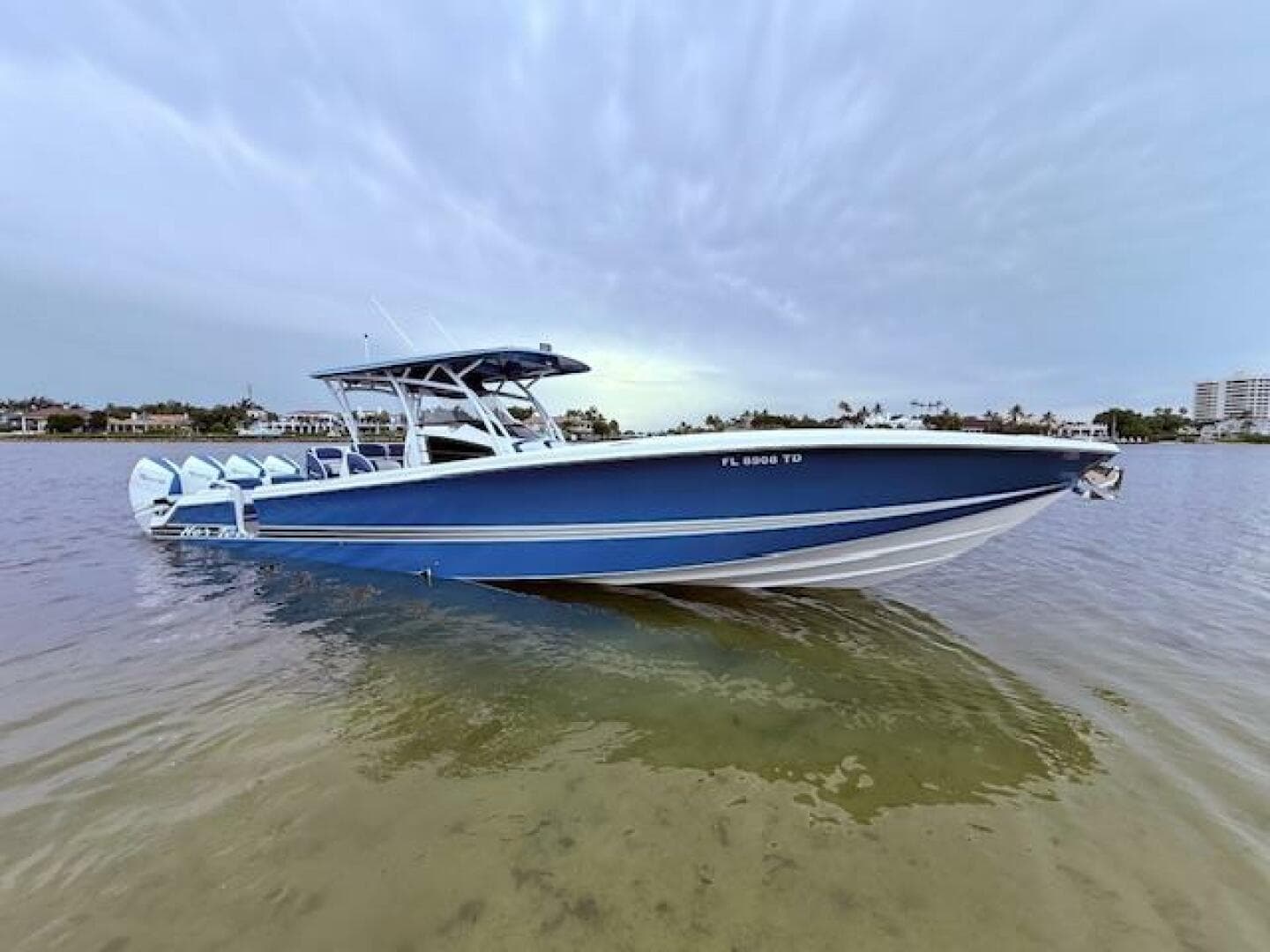 2022 Nor-Tech 390 Sport Center Console boat on calm water, showcasing sleek blue design.
